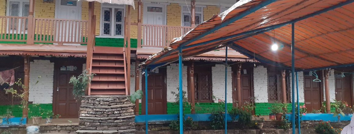The mustard and green painted lodge with its courtyard