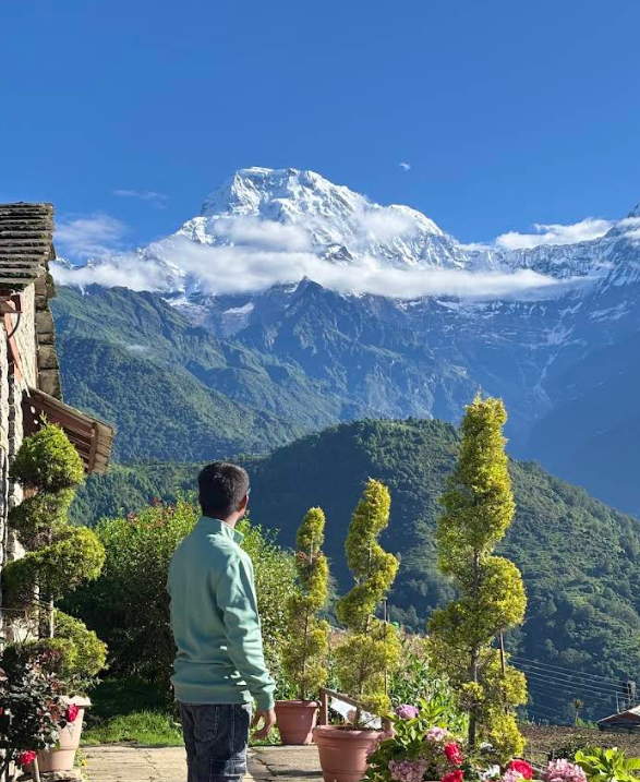 A guest looking out from the garden at the Annapurna range